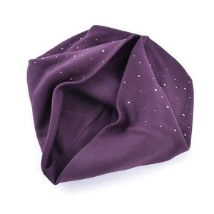 Detail shot of purple knit beanie with silver rhinestone studs on a white background