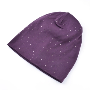 Detailed flat lay of purple knitted beanie with silver rhinestone and stud patterns