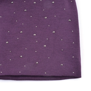 Close-up of purple knit fabric texture with sparkling silver rhinestone embellishments