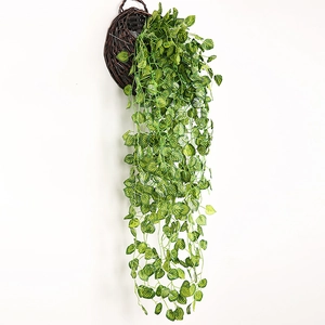 Artificial hanging ivy plant with lush green leaves in a woven brown basket on white background