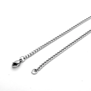Detail of silver stainless steel curb chain with secure lobster clasp closure on white base