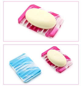 Detail of silicone soap dish showing pink and blue marble textures with drainage slots