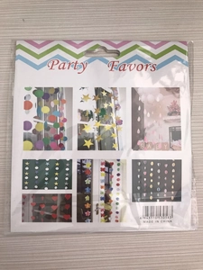 Detail of party favor set featuring gold stars and circles in professional packaging