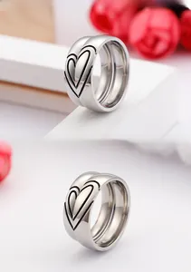 Detailed macro view of heart pattern engravings on polished silver titanium steel rings