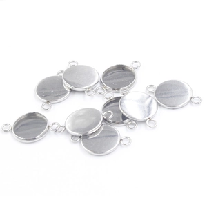 Polished stainless steel round pendant trays for DIY jewelry making on white background
