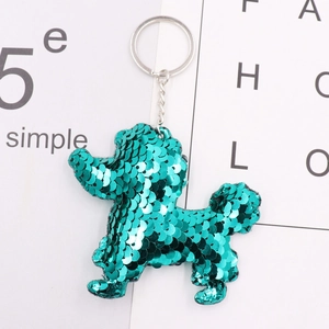 Close-up of green sequin poodle keychain with silver metal ring on white background