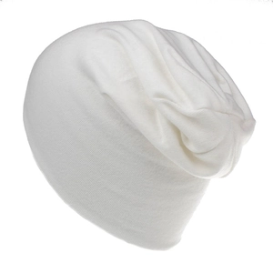 Detail shot showing the soft cotton knit texture and slouchy design of a white beanie