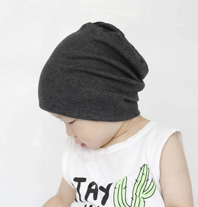 Detailed view of dark grey cotton slouchy beanie on toddler for autumn and winter wear