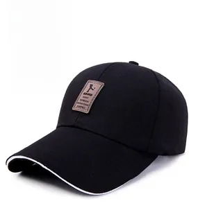 Close-up of black cotton baseball cap featuring brown leather patch and white sandwich brim