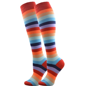 Detail of colorful rainbow striped mid-calf socks featuring reinforced red heel and toe