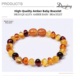 Detail of Baltic amber baby bracelet with irregular polished cognac and lemon beads