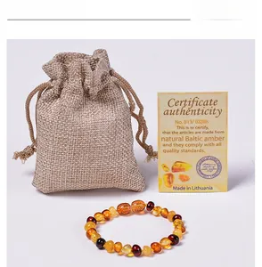 Baltic amber baby bracelet with colorful beads, linen pouch and certificate card