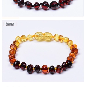 Macro shot of irregular Baltic amber beads in a rainbow gradient for baby bracelets