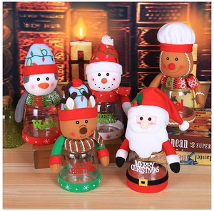 Detail of Christmas candy jars with cute plush Santa, snowman and reindeer character lids