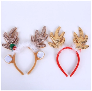 Detail view of brown plush reindeer antlers and red sequined Christmas headbands on white