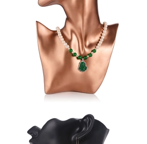 Detailed view of resin bust stand displaying a green Buddha pendant with pearl necklace