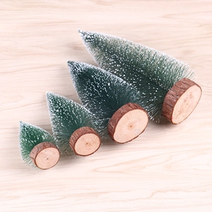 Set of four mini flocked Christmas trees with natural wood bases for desk decoration