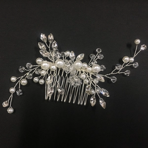 Detail showing white imitation pearls and faceted crystals on a silver bridal hair comb