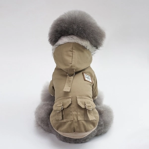 Detail view of khaki dog winter coat featuring a grey faux fur collar and functional cargo pockets