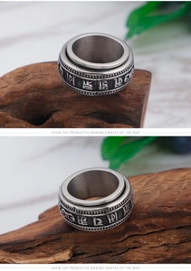 Detailed macro of vintage stainless steel rotating ring with engraved Buddhist mantras