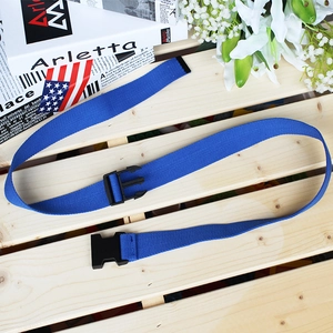 Blue nylon woven tactical belt with black plastic buckle on a light wood tray