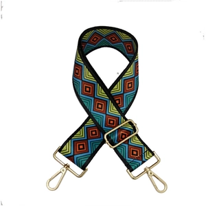 Detailed view of wide woven colorful geometric pattern strap with gold metal buckles