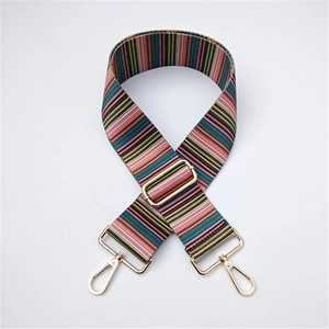Detail of colorful striped fabric shoulder strap with gold metal buckle and swivel hooks