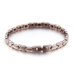 Rose gold magnetic health bracelet with X-link pattern and metallic therapy stones