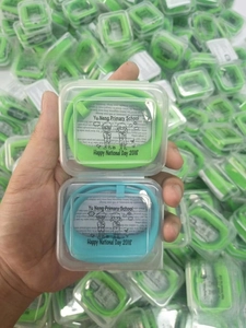 Detailed view of silicone pedometer wristbands in clear cases for Yu Neng Primary School