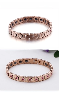 Rose gold magnetic therapy bracelet with red stones and stainless steel finish