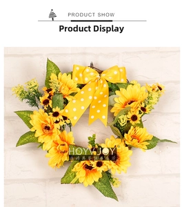Detailed view of yellow sunflower wreath with green leaves and a polka dot satin bow