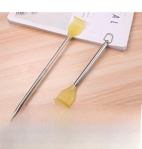 Detail view of telescopic back scratcher with yellow plastic claw and stainless steel handle