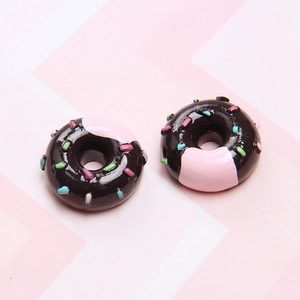 Detailed close-up of resin chocolate doughnuts with pink frosting and colorful sprinkles