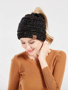 Detail of black mixed-color ponytail beanie featuring a CC leather patch and top opening