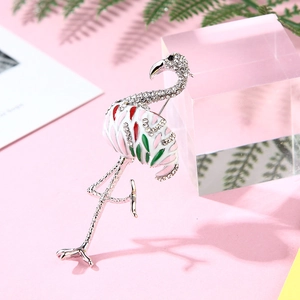 Elegant flamingo brooch with pink enamel and white crystals on pink background