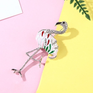 Detail of flamingo brooch with pink enamel and sparkling crystals on leaf background