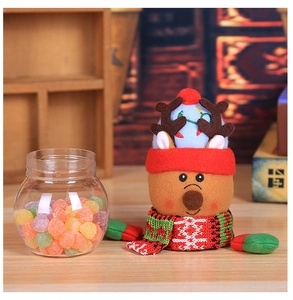 Detailed view of a Christmas reindeer candy jar with a felt head and a knitted scarf