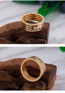 Macro detail of gold titanium couple ring with vintage nautical engraving on wood
