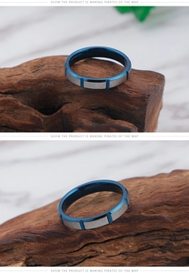 Detail view of the brushed silver finish and blue inner band of the stainless steel ring