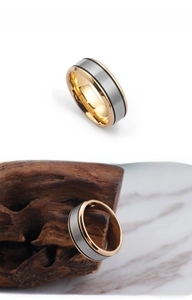 Macro shot of titanium steel ring with matte brushed silver and gold polished edges
