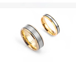 Detail of 5mm and 7mm titanium steel rings with brushed silver center and gold edges