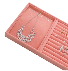 Pink velvet jewelry tray detail with necklace display section and ring slots