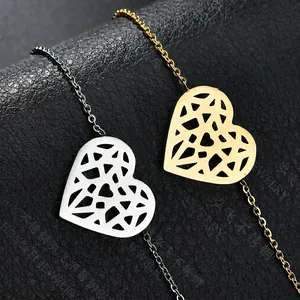 Minimalist stainless steel heart hollow pendants in gold and silver on black background