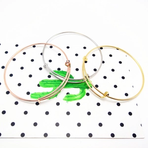 Adjustable wire bracelets in gold, silver, and rose gold finish on a decorative card