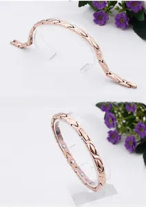 Detail of rose gold stainless steel leaf bracelet with inner magnetic therapy beads