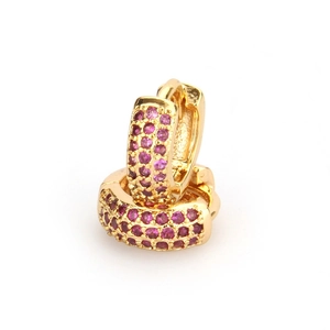Gold plated huggie earrings with three rows of purple cubic zirconia on white background