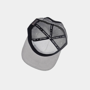 Internal detail of a light gray snapback hat showing the six-panel crown and inner stitching
