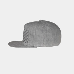 Detail view of grey knit snapback cap featuring horizontal striped embroidery textures
