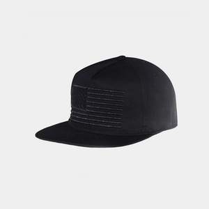 Close-up of high-density American flag embroidery on a black snapback flat brim cap