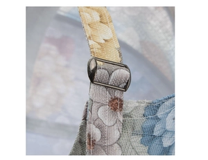 Macro shot of vintage floral canvas baseball cap with adjustable bronze metal buckle